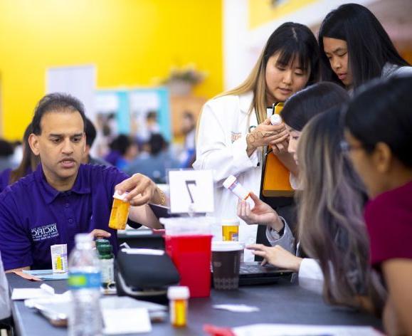 Raj Patel with PharmD students at Medicare Part D Outreach Clinic event